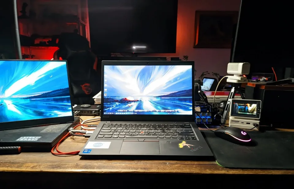 Two laptops and desktop equipment on a workbench